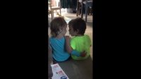 Little girl preciously consoles her twin brother